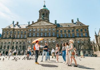 Highlights Walking Tour at Dam Square in front of the Royal Palace